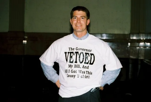 Ron Tupa in a shirt reading 'The Governor vetoed my bill and all I got was this lousy t-shirt!'